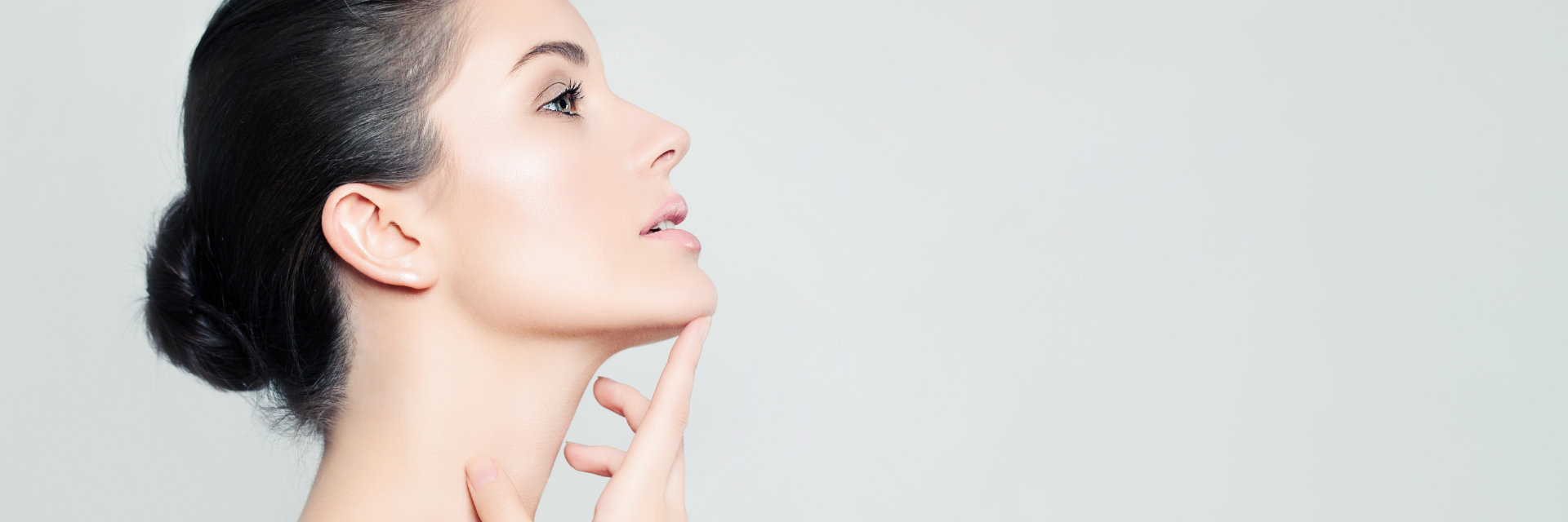 Profile of a face and neck of a beautiful dark-haired woman.